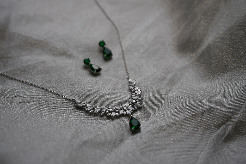 Jewelry set with necklace and earrings on a gray fabric background