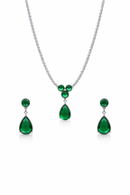 Emerald necklace and earrings set on a white background