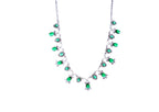 Necklace with green gemstones and sharp cut dimonds  on a white background