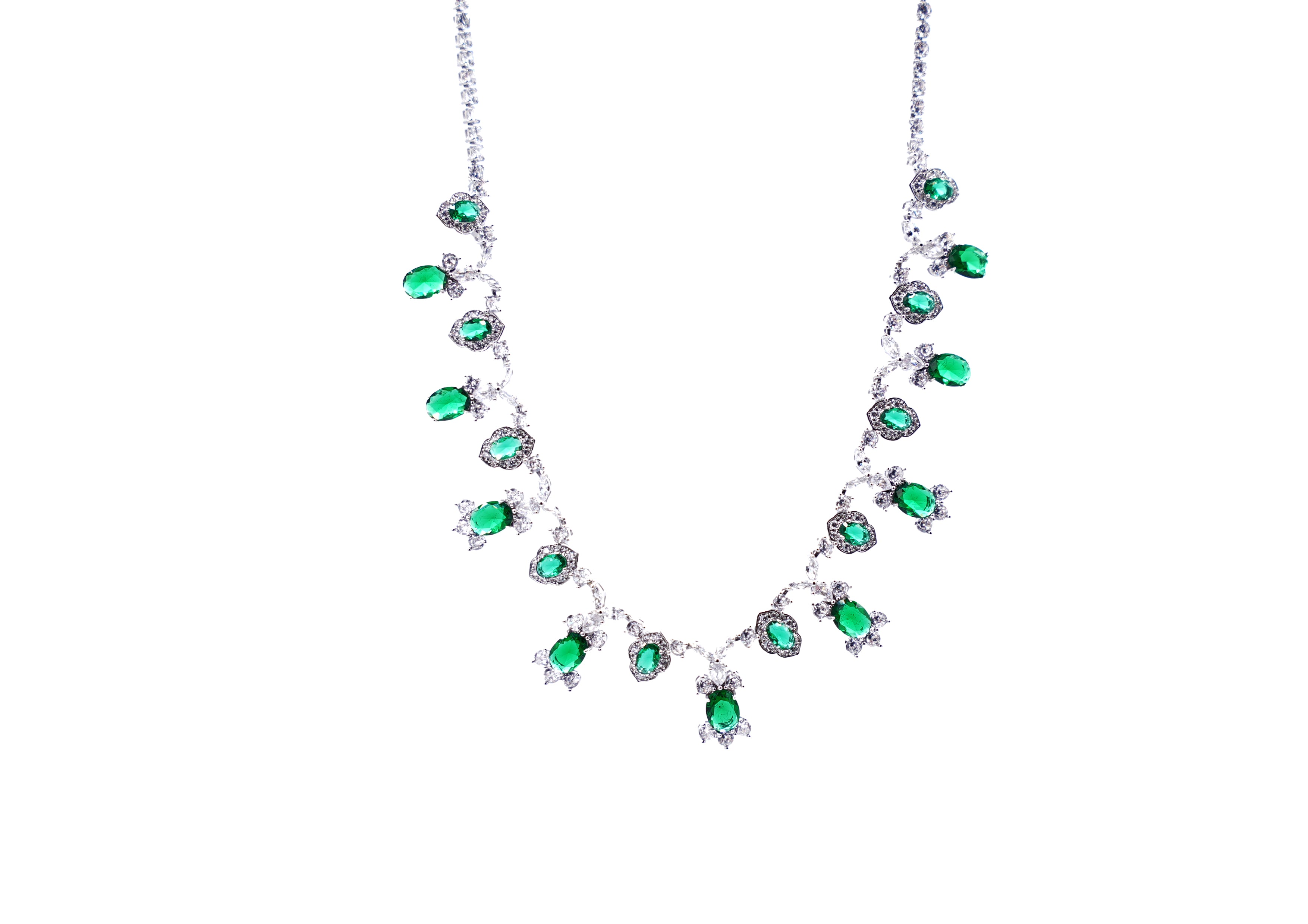 Necklace with green gemstones and sharp cut dimonds  on a white background